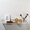 Wandregal Grid 01 von weld & co in Hellgrau, inszeniert fürs Badezimmer mit Postkarte von Navucko, Haarbürste, Chanel No 5, Lippenstiften und Glas mit Puderpinseln und kleiner Tube.